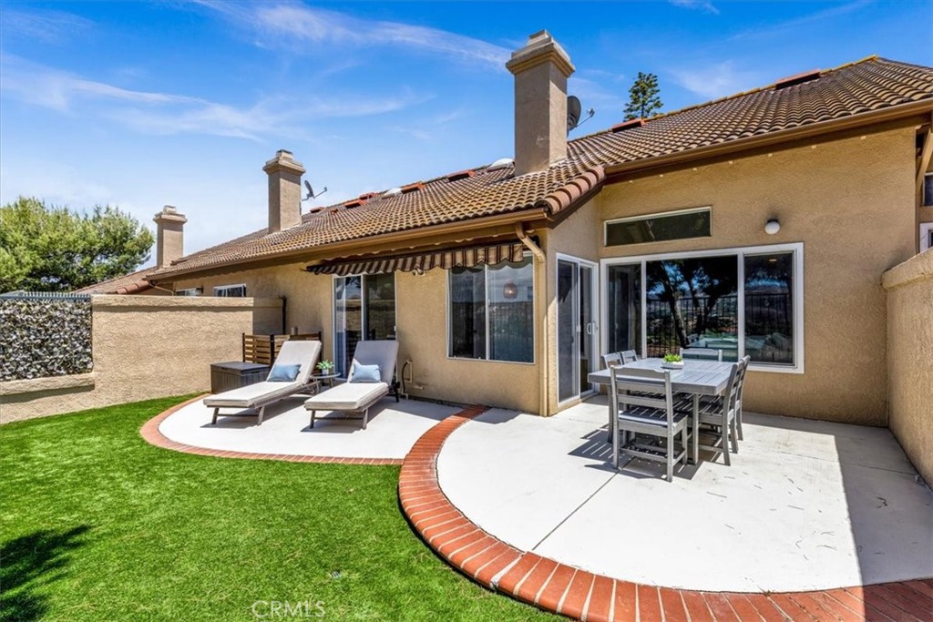 he back patio can be accessed in two ways—through the living room and directly from the primary bedroom—enhancing seamle - 27355 Paseo Laguna, San Juan Capistrano CA 92675 - photo 36