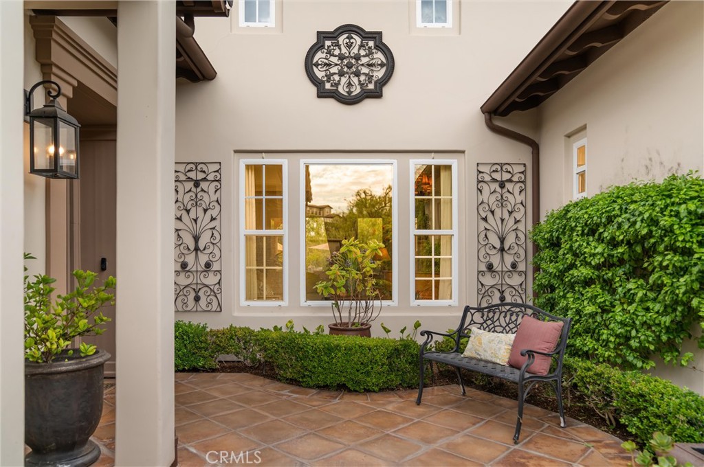 Private gated courtyard with decorative ironwork, and a welcoming outdoor sitting area. - 27532 Calle De La Rosa, San Juan Capistrano CA 92675 - photo 3