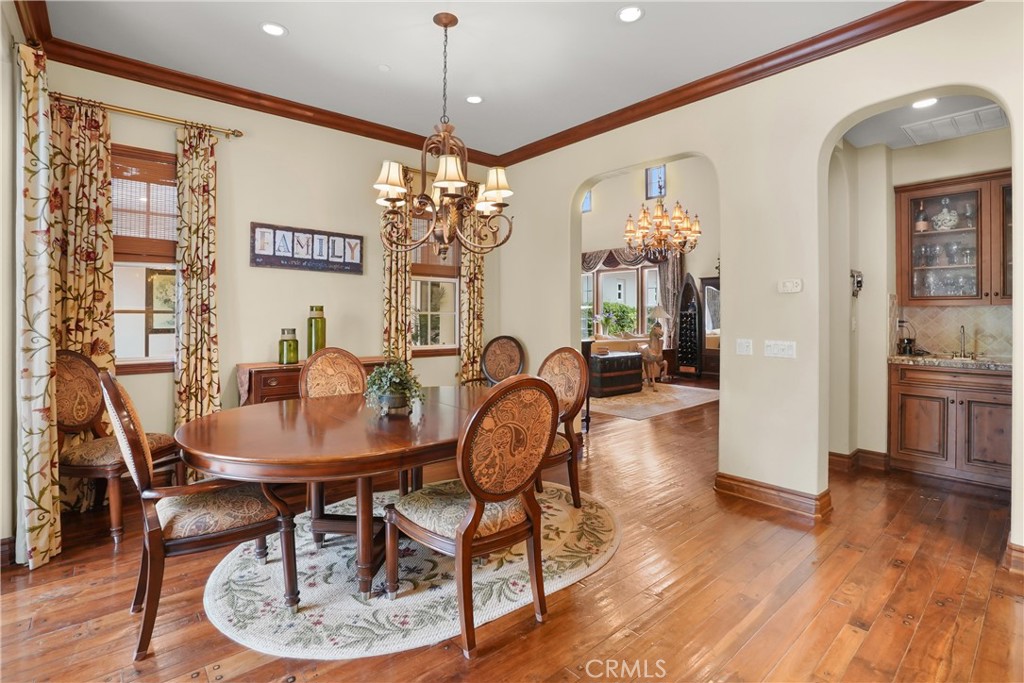 Elegant formal dining room with rich hardwood flooring and seamless access to the main living areas. - 27532 Calle De La Rosa, San Juan Capistrano CA 92675 - photo 17