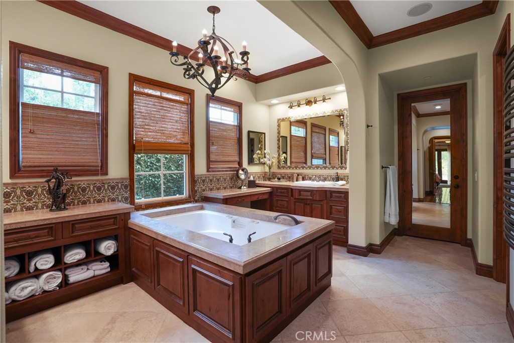 Spa-inspired primary bath with a soaking tub, dual vanities, separate makeup station, and custom cabinetry. - 27532 Calle De La Rosa, San Juan Capistrano CA 92675 - photo 44