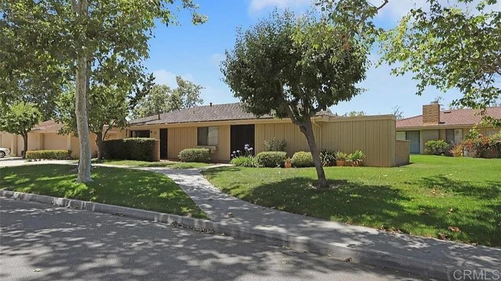 Tree and grass lined sidewalk leads to front yard with easy access into the home. - 27541 Avenida Larga, San Juan Capistrano CA 92675 - photo 1