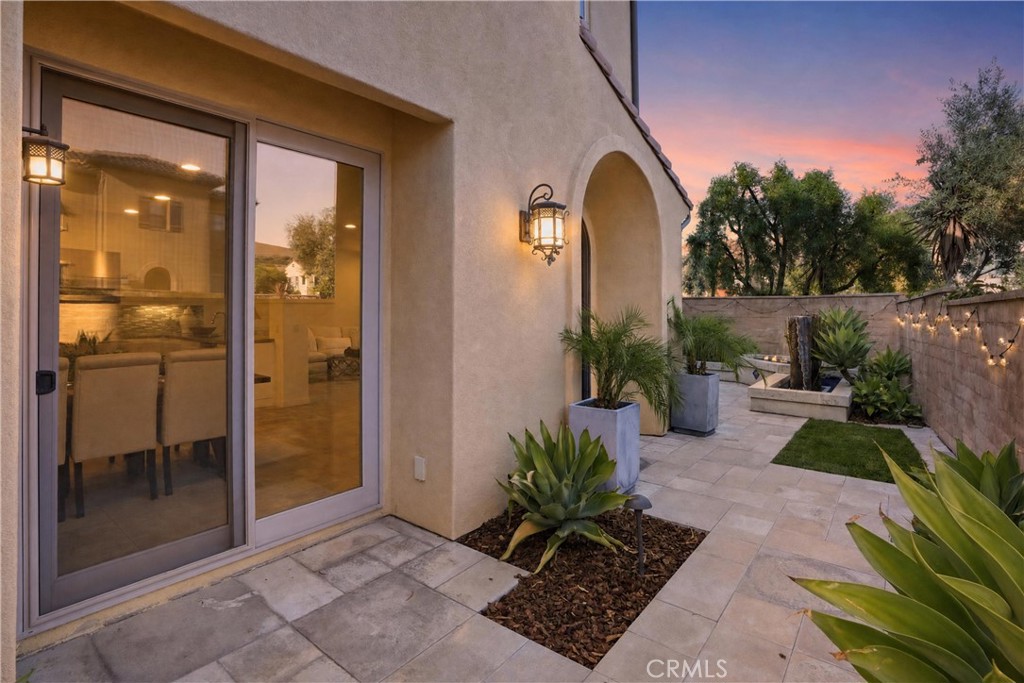 Private courtyard-style outdoor space with custom fountain, hardscape, landscaping, and direct access to the home’s inte - 28242 Camino Del Rio, San Juan Capistrano CA 92675 - photo 3