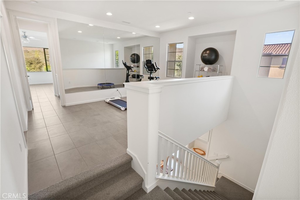 Upstairs loft currently utilized as a home fitness area, offering flexible space for a variety of uses. - 28242 Camino Del Rio, San Juan Capistrano CA 92675 - photo 17