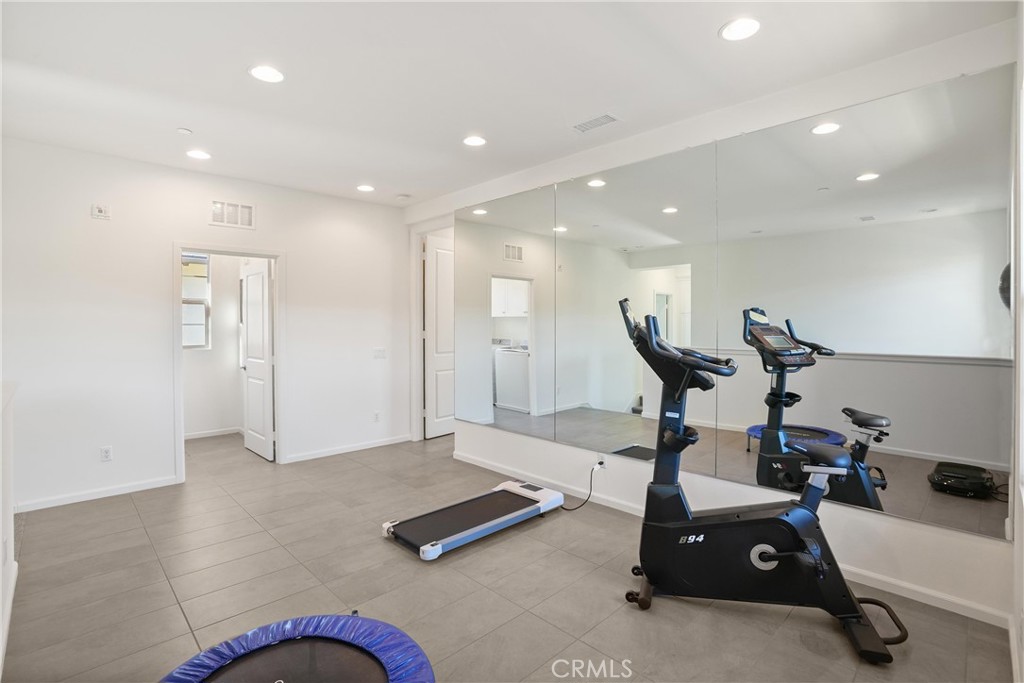 Upstairs loft with a full mirrored wall, recessed lighting, and ample space for a variety of uses. - 28242 Camino Del Rio, San Juan Capistrano CA 92675 - photo 19