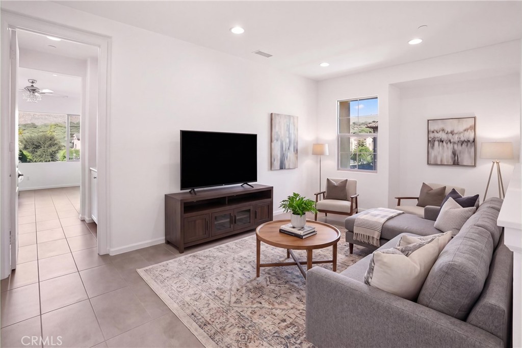 VIRTUALLY STAGED Upstairs loft shown as a comfortable secondary living area, highlighting the versatility and generous s - 28242 Camino Del Rio, San Juan Capistrano CA 92675 - photo 21