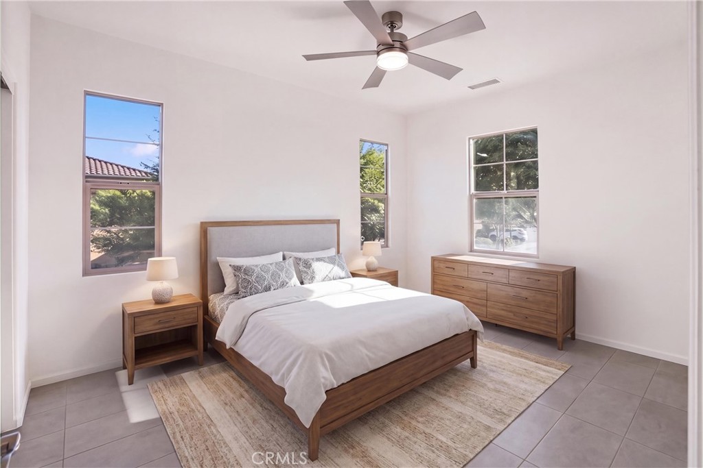 VIRTUALLY STAGED Secondary bedroom showcasing the room’s spacious layout, natural light, and multiple windows. - 28242 Camino Del Rio, San Juan Capistrano CA 92675 - photo 25