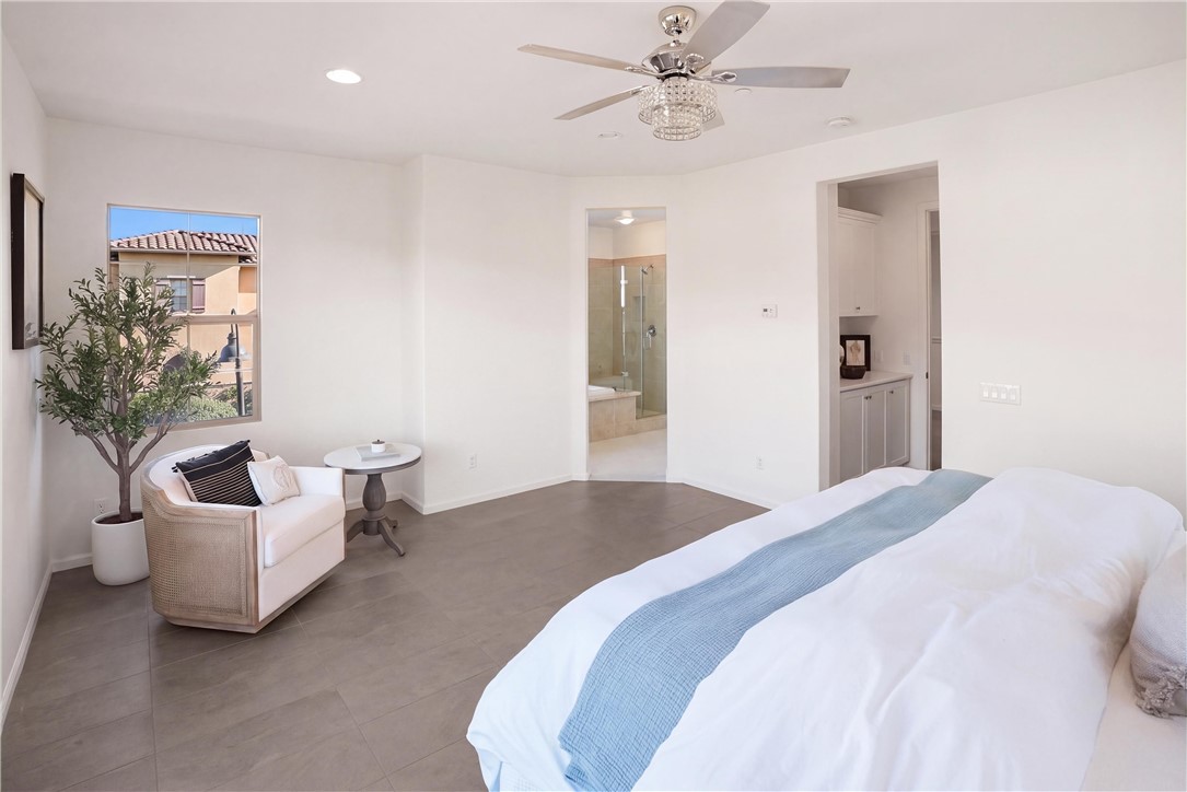 Spacious primary suite with a dedicated sitting area and direct access to the primary bathroom. - 28242 Camino Del Rio, San Juan Capistrano CA 92675 - photo 30