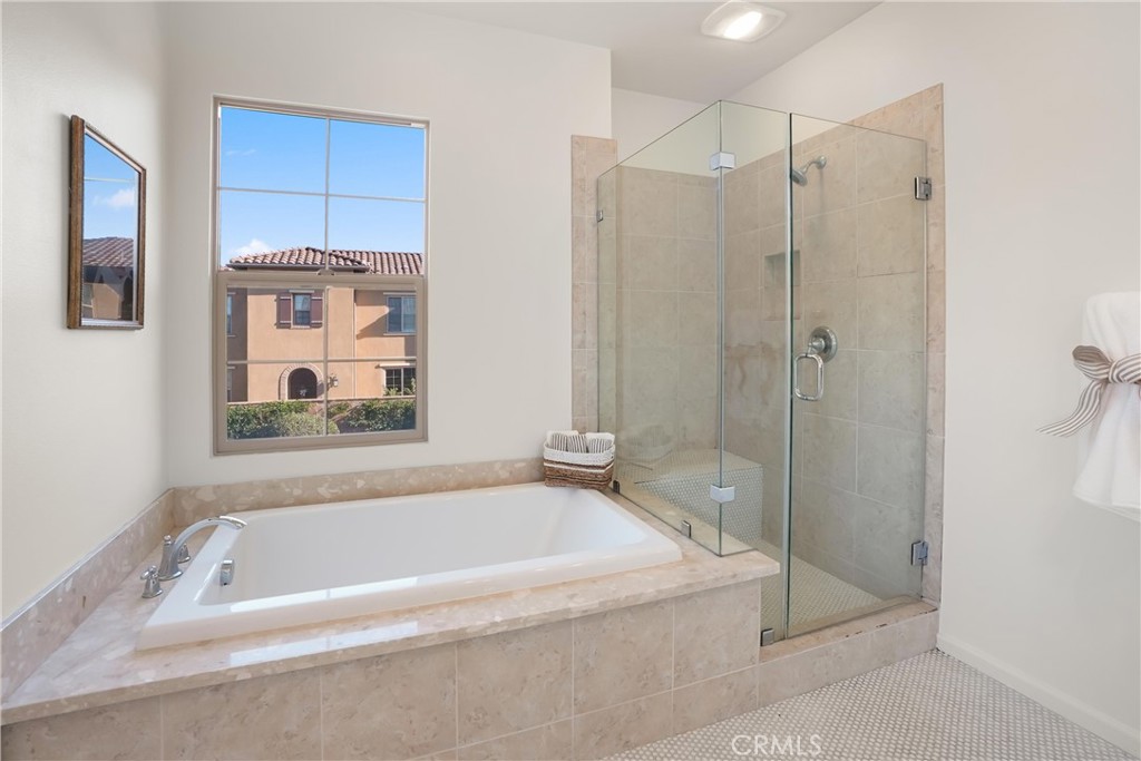 Primary bathroom featuring a soaking tub and separate glass enclosed walk in shower. - 28242 Camino Del Rio, San Juan Capistrano CA 92675 - photo 32