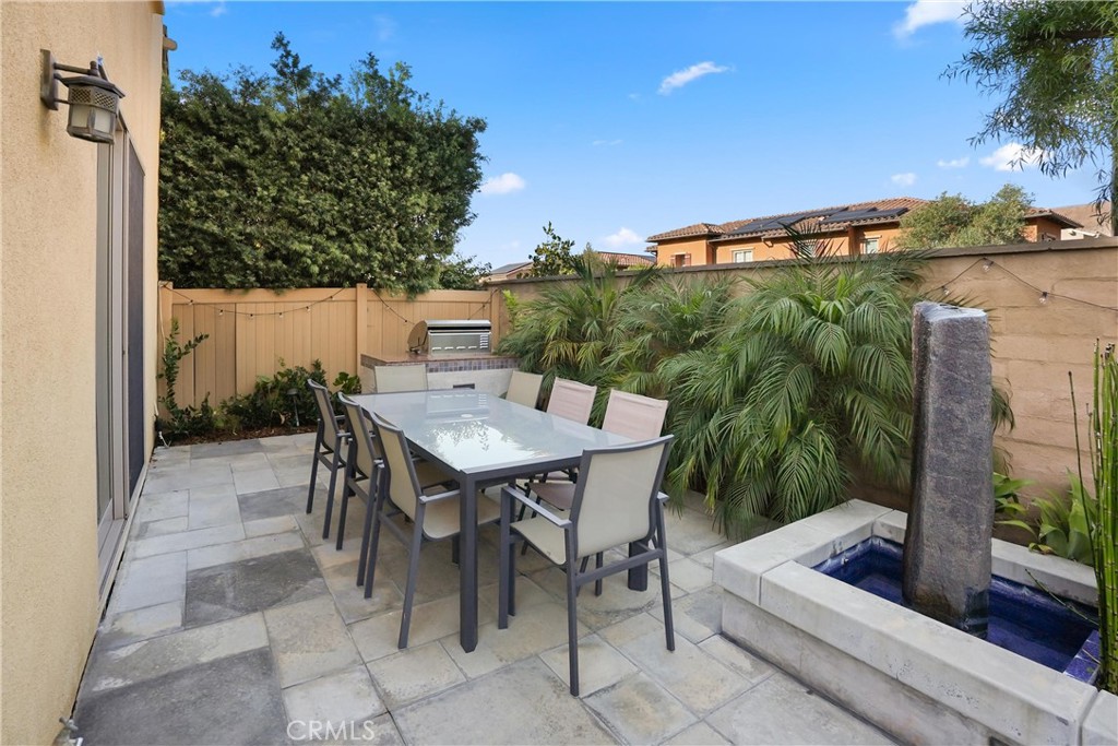 Additional view of the backyard showcasing the spacious patio, built in barbecue, and water feature. - 28242 Camino Del Rio, San Juan Capistrano CA 92675 - photo 36