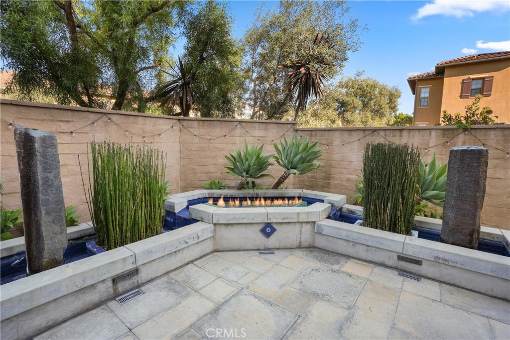 Landscaped backyard retreat featuring decorative water features, fire feature, and built in seating. - 28242 Camino Del Rio, San Juan Capistrano CA 92675 - photo 38