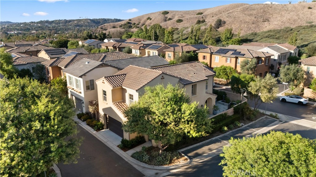 Aerial view showcasing the home, surrounding neighborhood, and scenic hillside setting. - 28242 Camino Del Rio, San Juan Capistrano CA 92675 - photo 40