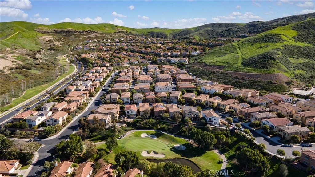 Aerial view showcasing the community surrounded by rolling hills with the golf course in the foreground. - 28242 Camino Del Rio, San Juan Capistrano CA 92675 - photo 44