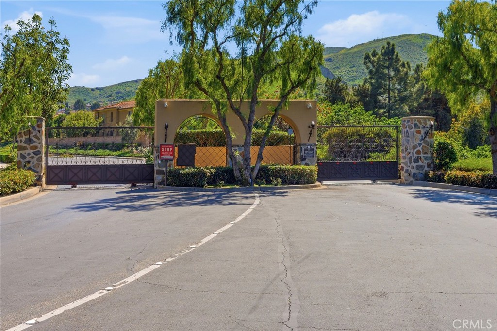 Gated entrance to the Campanilla community, offering controlled access in a picturesque hillside setting. - 28242 Camino Del Rio, San Juan Capistrano CA 92675 - photo 50