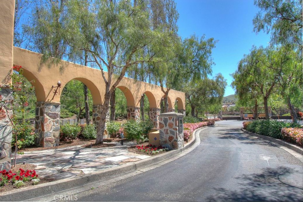 Landscaped entry within the gated Campanilla community, surrounded by mature trees and scenic hillsides. - 28242 Camino Del Rio, San Juan Capistrano CA 92675 - photo 51
