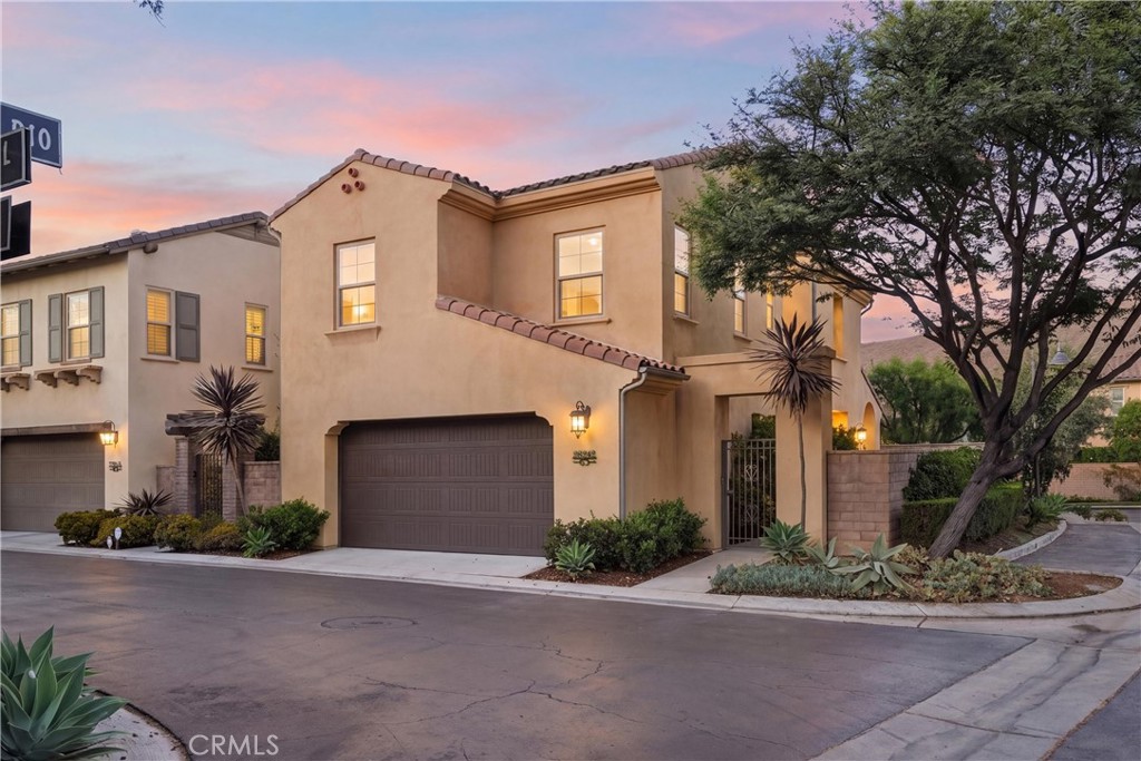 Twilight exterior showcasing the home’s desirable corner lot location, Spanish-inspired architecture, mature landscaping - 28242 Camino Del Rio, San Juan Capistrano CA 92675 - photo 65
