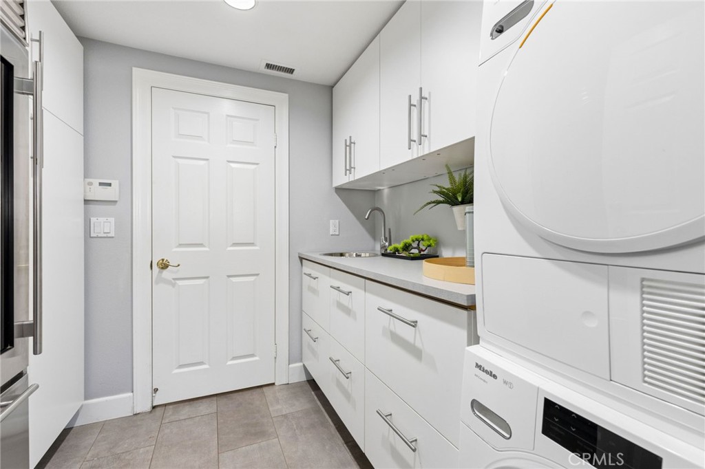 Main floor laundry room with garage access (2nd is upstairs in the primary bathroom) - 28382 Calle Pinon, San Juan Capistrano CA 92675 - photo 26