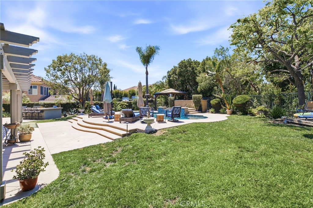 Expansive backyard with plenty of seating areas and grass - 28382 Calle Pinon, San Juan Capistrano CA 92675 - photo 32