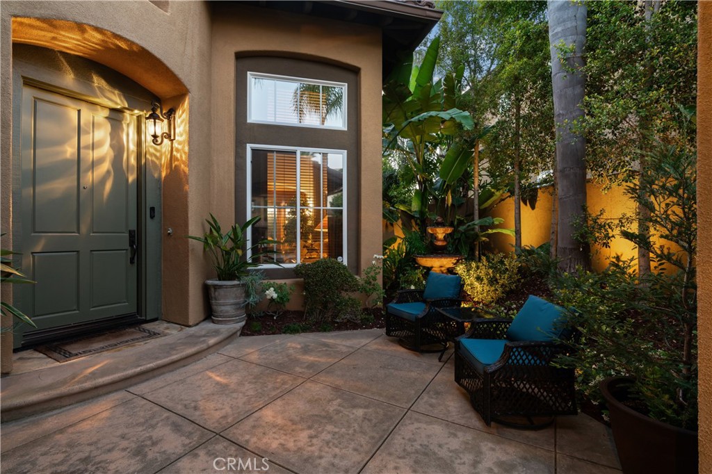 Serene front courtyard framed by mature landscaping and tranquil fountain accent - 31251 Calle Bolero, San Juan Capistrano CA 92675 - photo 4