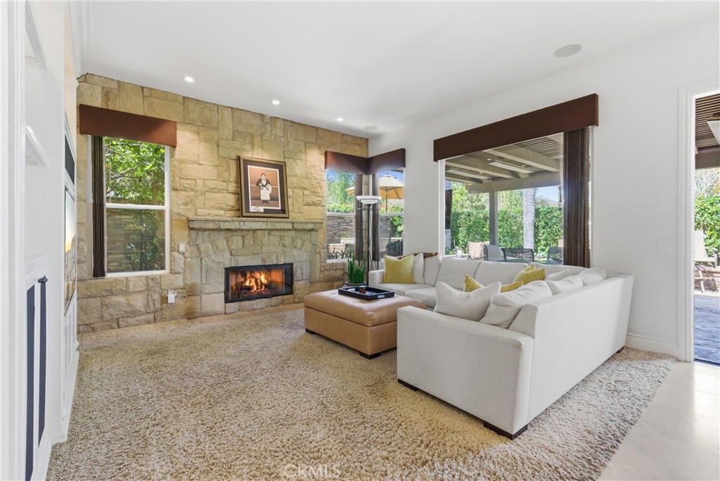 Inviting living space featuring a fireplace and seamless indoor-outdoor flow to the backyard entertaining areas - 31251 Calle Bolero, San Juan Capistrano CA 92675 - photo 10