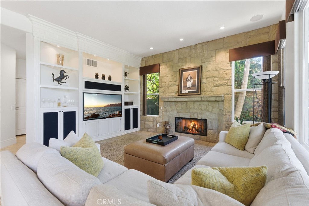 Inviting living space featuring a fireplace and seamless indoor-outdoor flow to the backyard entertaining areas - 31251 Calle Bolero, San Juan Capistrano CA 92675 - photo 11