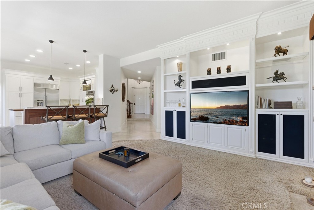 Inviting living space featuring a fireplace and seamless indoor-outdoor flow to the backyard entertaining areas. - 31251 Calle Bolero, San Juan Capistrano CA 92675 - photo 12