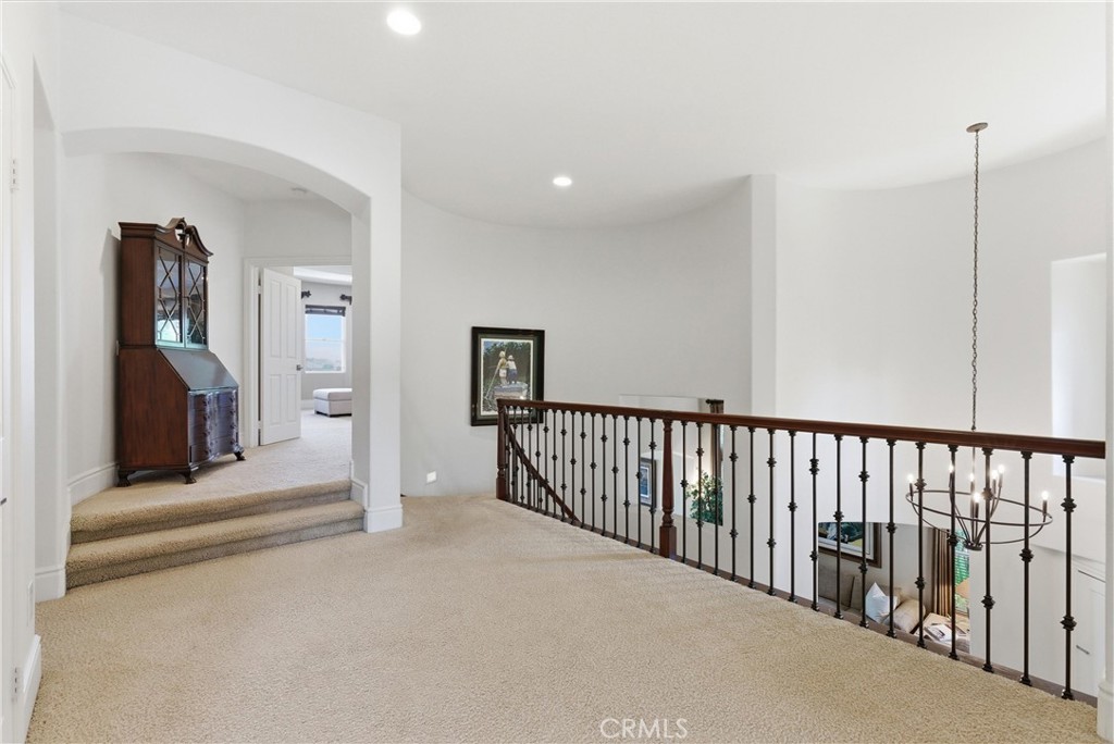 pacious upper-level landing featuring wrought iron staircase accents - 31251 Calle Bolero, San Juan Capistrano CA 92675 - photo 23