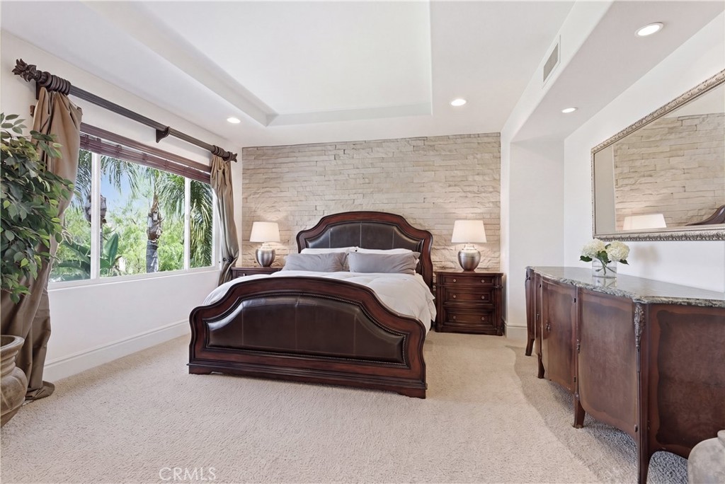Spacious primary suite with a private sitting area, abundant natural light, and picturesque hillside and neighborhood vi - 31251 Calle Bolero, San Juan Capistrano CA 92675 - photo 25