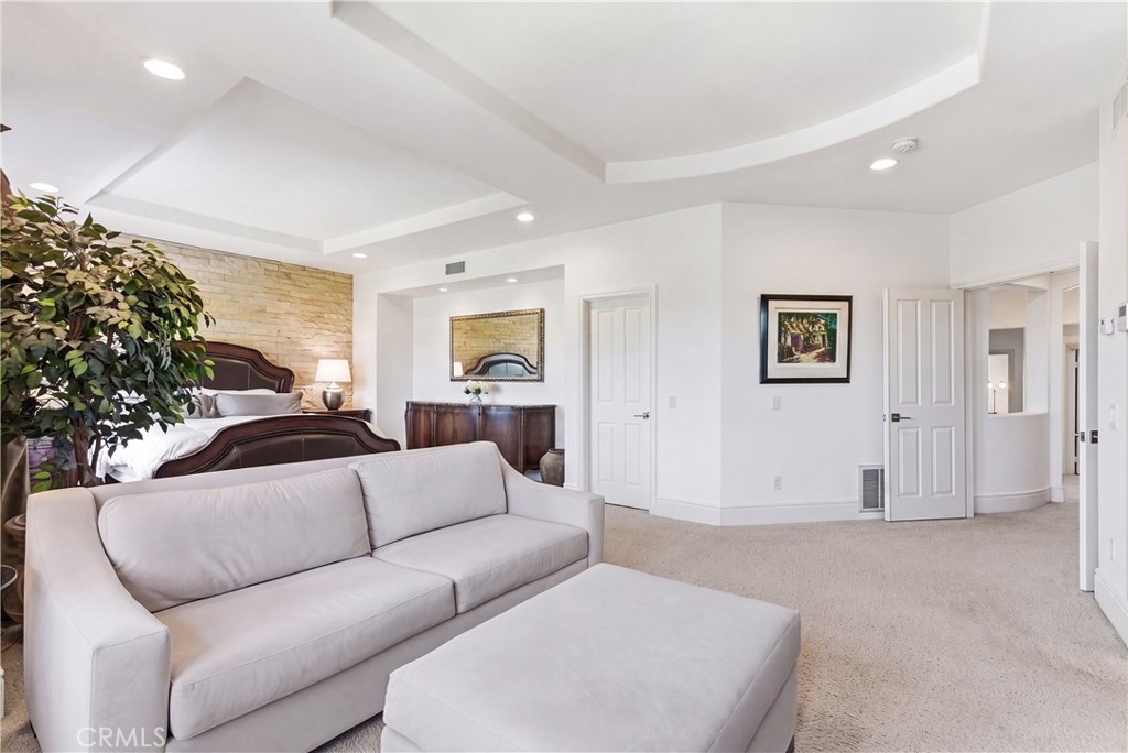 Spacious primary suite with a private sitting area, abundant natural light, and picturesque hillside and neighborhood vi - 31251 Calle Bolero, San Juan Capistrano CA 92675 - photo 27