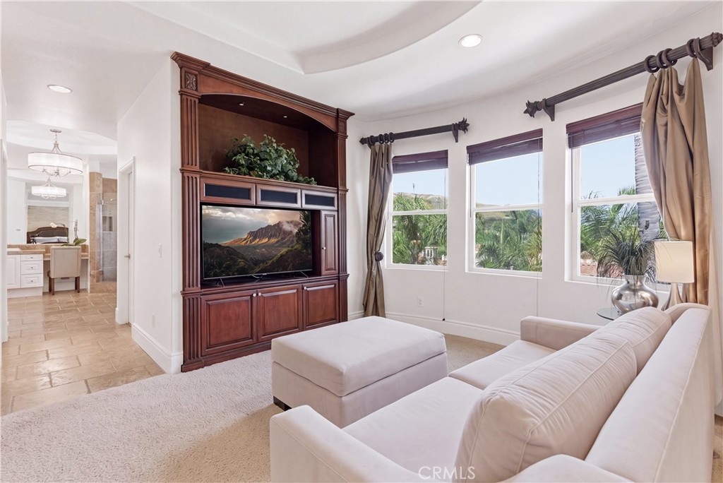 Spacious primary suite with a private sitting area, abundant natural light, and picturesque hillside and neighborhood vi - 31251 Calle Bolero, San Juan Capistrano CA 92675 - photo 28