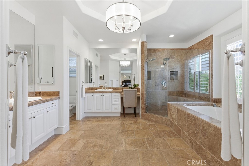 Spa-inspired primary bathroom with dual vanities, a soaking tub, and oversized walk-in shower - 31251 Calle Bolero, San Juan Capistrano CA 92675 - photo 31