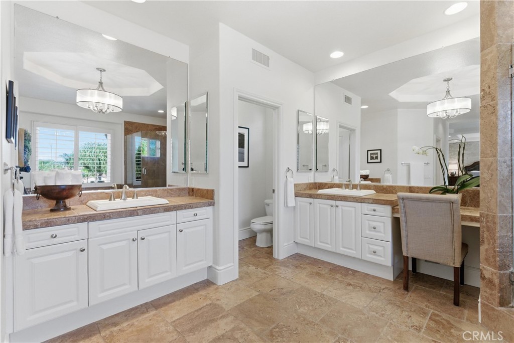 Spa-inspired primary bathroom with dual vanities, a soaking tub, and oversized walk-in shower - 31251 Calle Bolero, San Juan Capistrano CA 92675 - photo 33