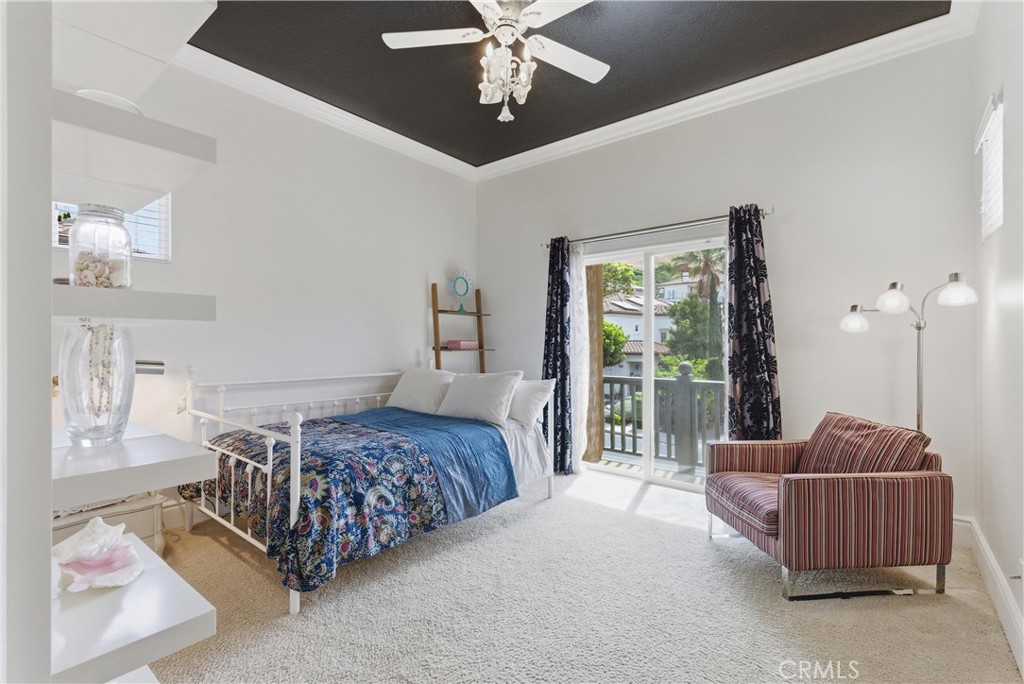 Secondary bedroom featuring a balcony, and abundant natural light - 31251 Calle Bolero, San Juan Capistrano CA 92675 - photo 34