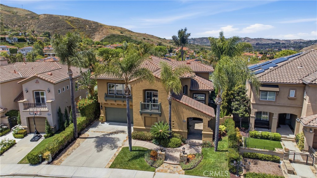 Elegant exterior with manicured landscaping and inviting curb appeal set along a quiet interior street - 31251 Calle Bolero, San Juan Capistrano CA 92675 - photo 71