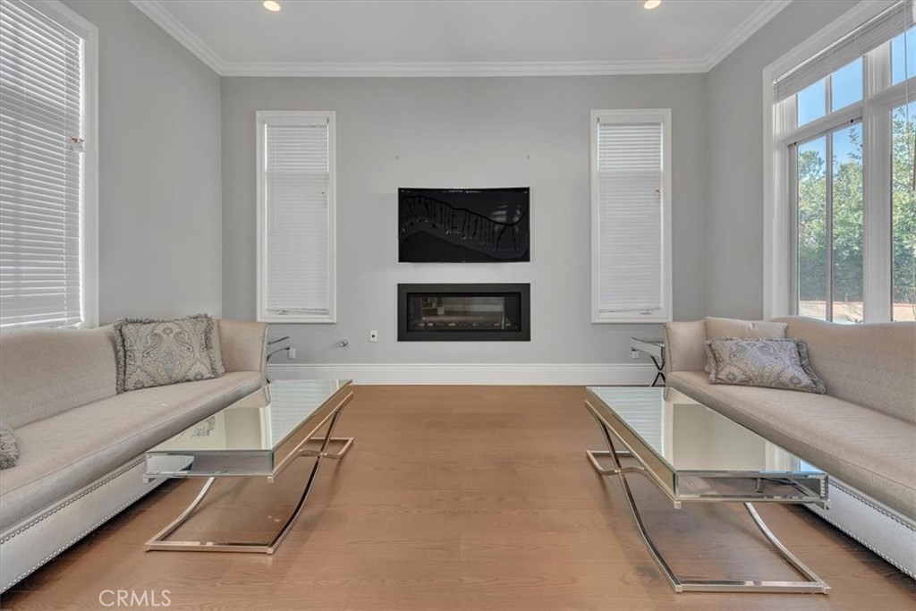 Formal Living Room with custom fireplace. Windows on three sides provides lots of natural light. - 31378 Juliana Farms Road, San Juan Capistrano CA 92675 - photo 8