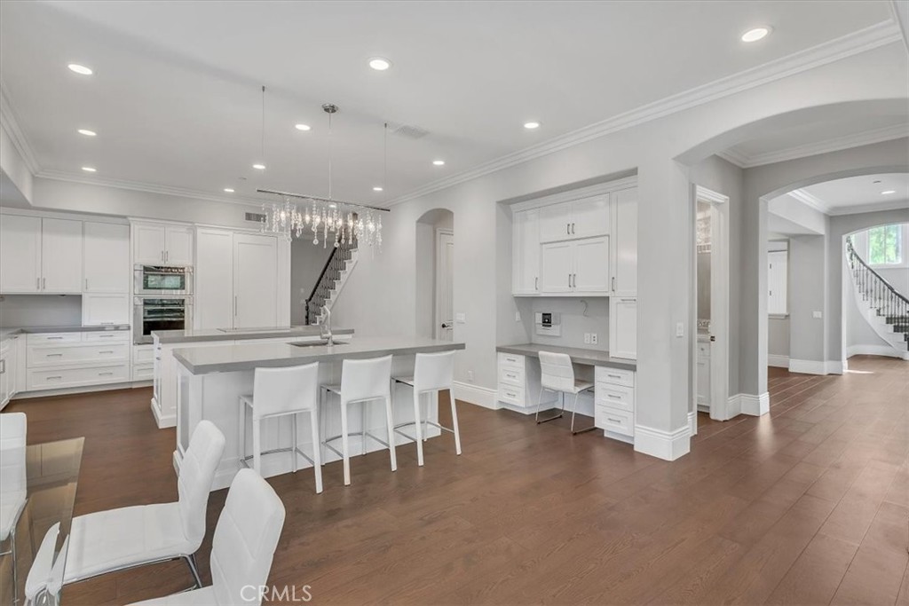 Beautifully finished kitchen and wide-plank flooring. Second staircase behind the kitchen - 31378 Juliana Farms Road, San Juan Capistrano CA 92675 - photo 16