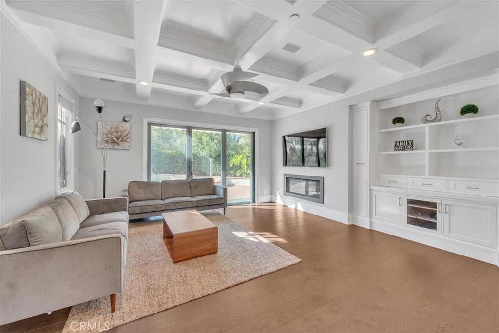 Spacious Family Room with Fireplace and views of the pool and spa - 31378 Juliana Farms Road, San Juan Capistrano CA 92675 - photo 17