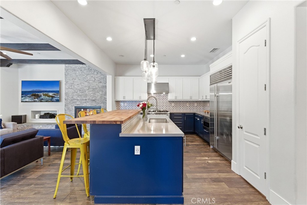 Remodeled chef’s kitchen with oversized butcher block island, custom blue cabinetry, designer pendant lighting, stainles - 31491 Carril De Maderas, San Juan Capistrano CA 92675 - photo 20