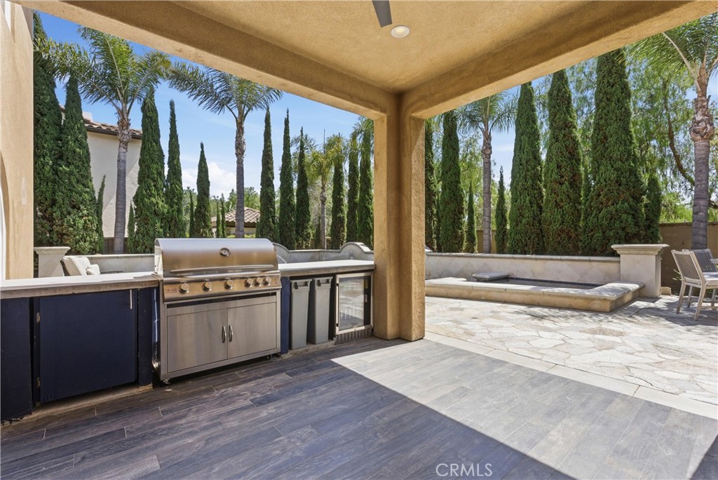 Outdoor kitchen with built-in BBQ, beverage refrigerator, storage, and serving bar - 31491 Carril De Maderas, San Juan Capistrano CA 92675 - photo 24