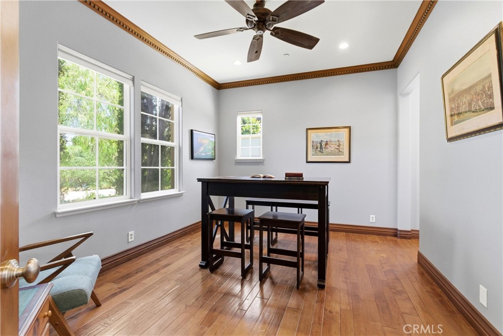 Main-level office/bedroom with rich hardwood flooring and adjacent full bath - 31491 Carril De Maderas, San Juan Capistrano CA 92675 - photo 34