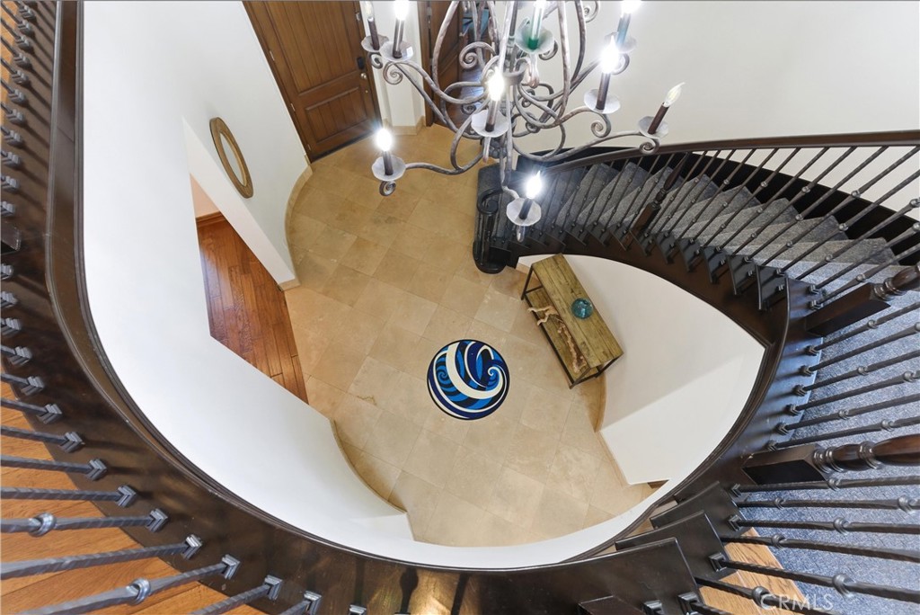 Dramatic curved staircase and soaring two-story entry create an unforgettable first impression, highlighted by wrought-i - 31491 Carril De Maderas, San Juan Capistrano CA 92675 - photo 37