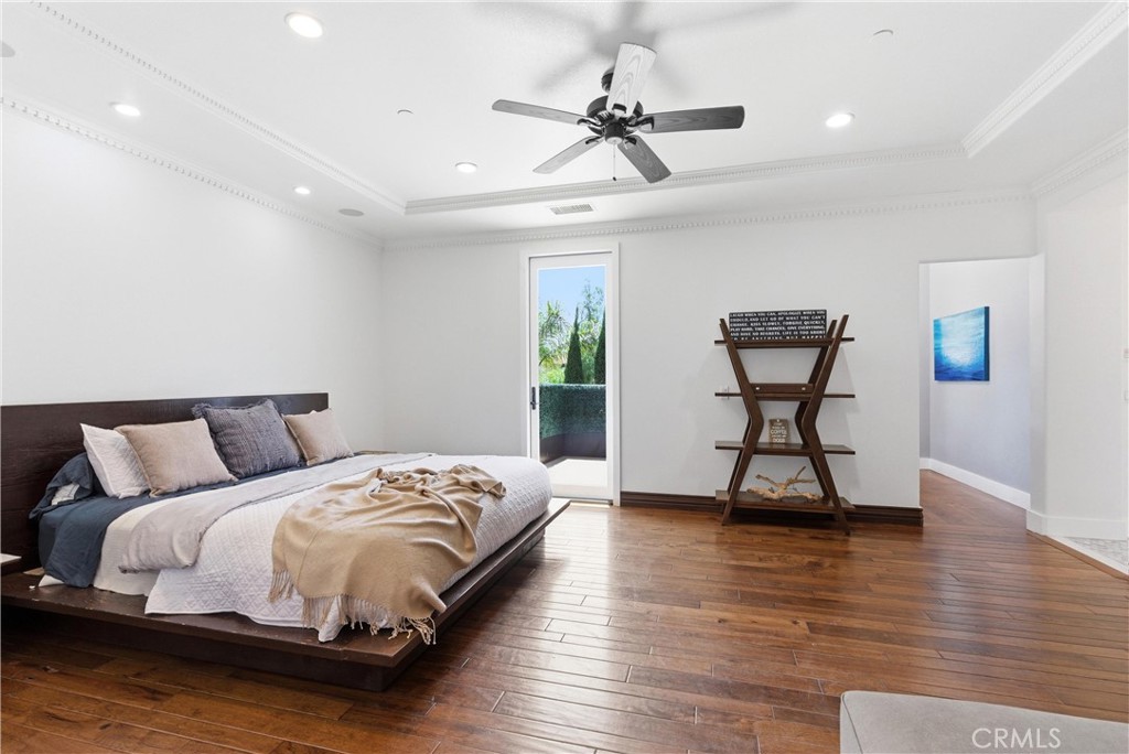 Expansive primary suite with hardwood flooring, fireplace retreat, oversized proportions, and private balcony access ove - 31491 Carril De Maderas, San Juan Capistrano CA 92675 - photo 40