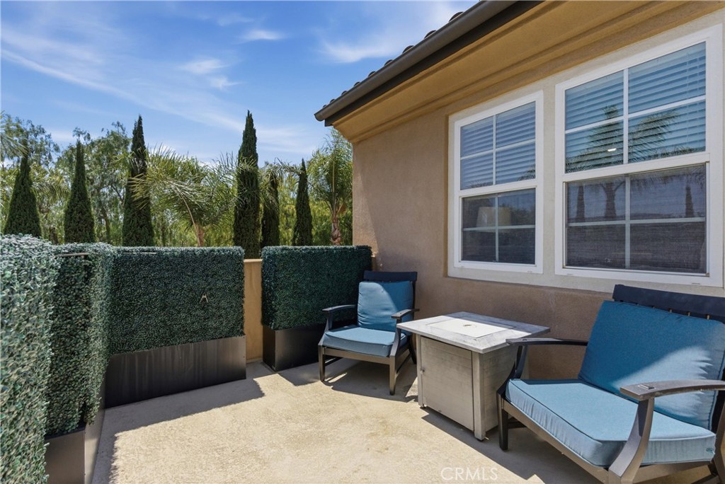 Private balcony off the primary suite overlooking lush mature landscaping with tranquil neighborhood and hillside views. - 31491 Carril De Maderas, San Juan Capistrano CA 92675 - photo 44