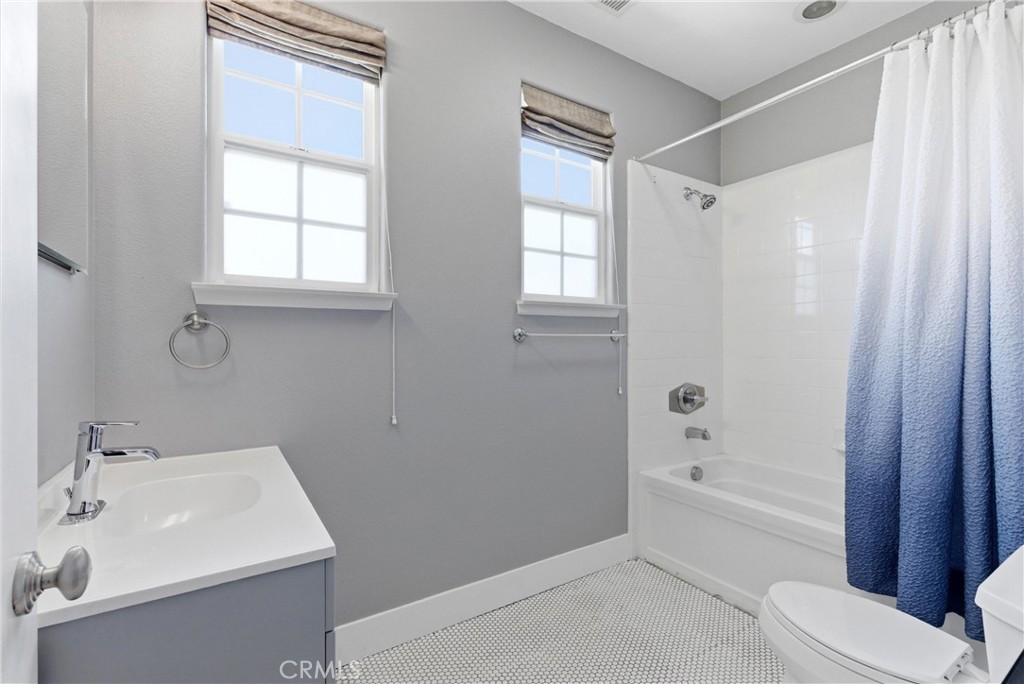 Secondary full bath with clean, timeless finishes including white tile surround, updated vanity, and abundant natural li - 31491 Carril De Maderas, San Juan Capistrano CA 92675 - photo 55