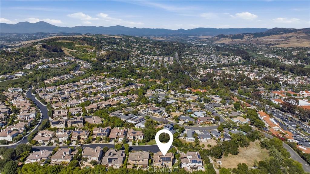 Aerial view showcasing Rancho Madrina’s hillside setting, surrounding neighborhoods, nearby golf course, and scenic moun - 31491 Carril De Maderas, San Juan Capistrano CA 92675 - photo 66