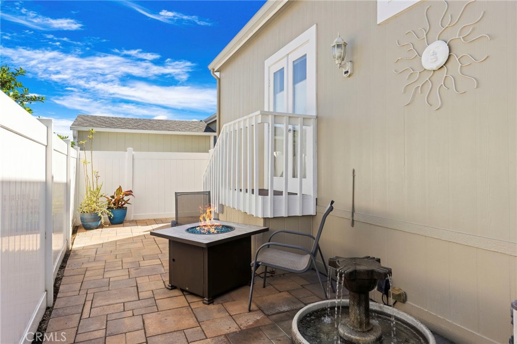 Back patio with pavers, fire table & fountain. - 32302 Alipaz 292, San Juan Capistrano CA 92675 - photo 22