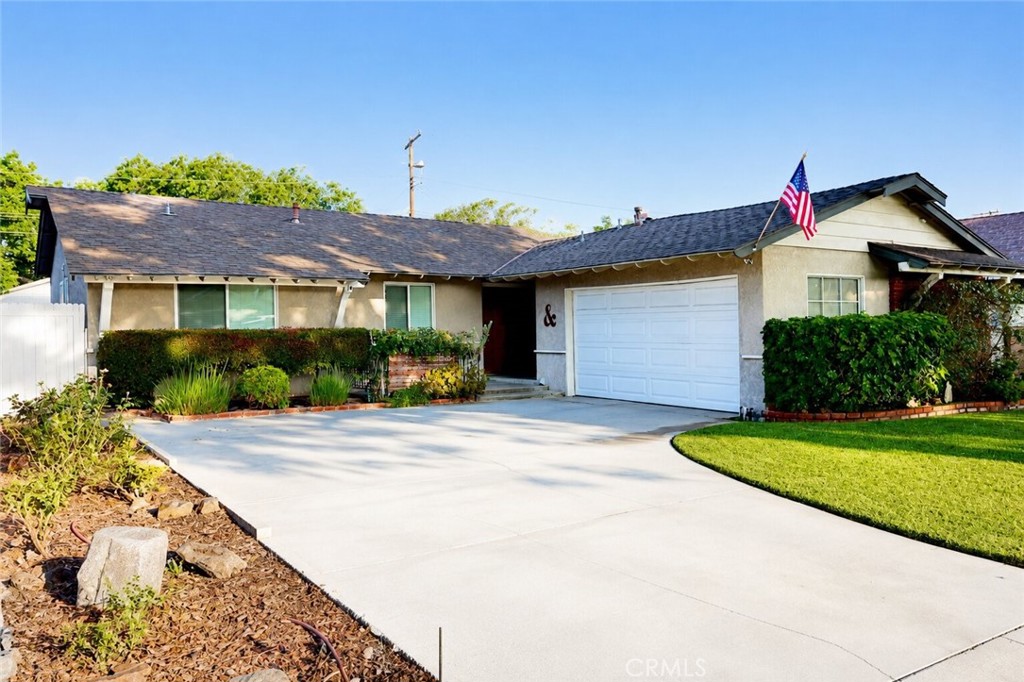 Inviting curb appeal welcomes you home with mature landscaping, an oversized driveway, and a spacious two-car garage, cr - 1506 Eastside Avenue, Santa Ana CA 92701 - photo 1