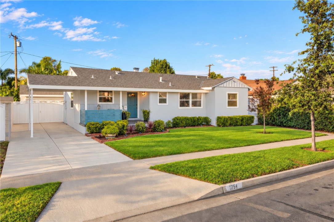 Cared for inside and out, this single-story Riverview home pairs classic curb appeal with a lush front lawn, a welcoming - 1711 W 21st, Santa Ana CA 92706 - photo 2