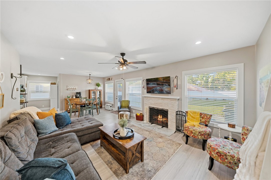 Large dual pane windows, blinds, recessed lighting, area fan and fireplace. - 1711 W 21st, Santa Ana CA 92706 - photo 11