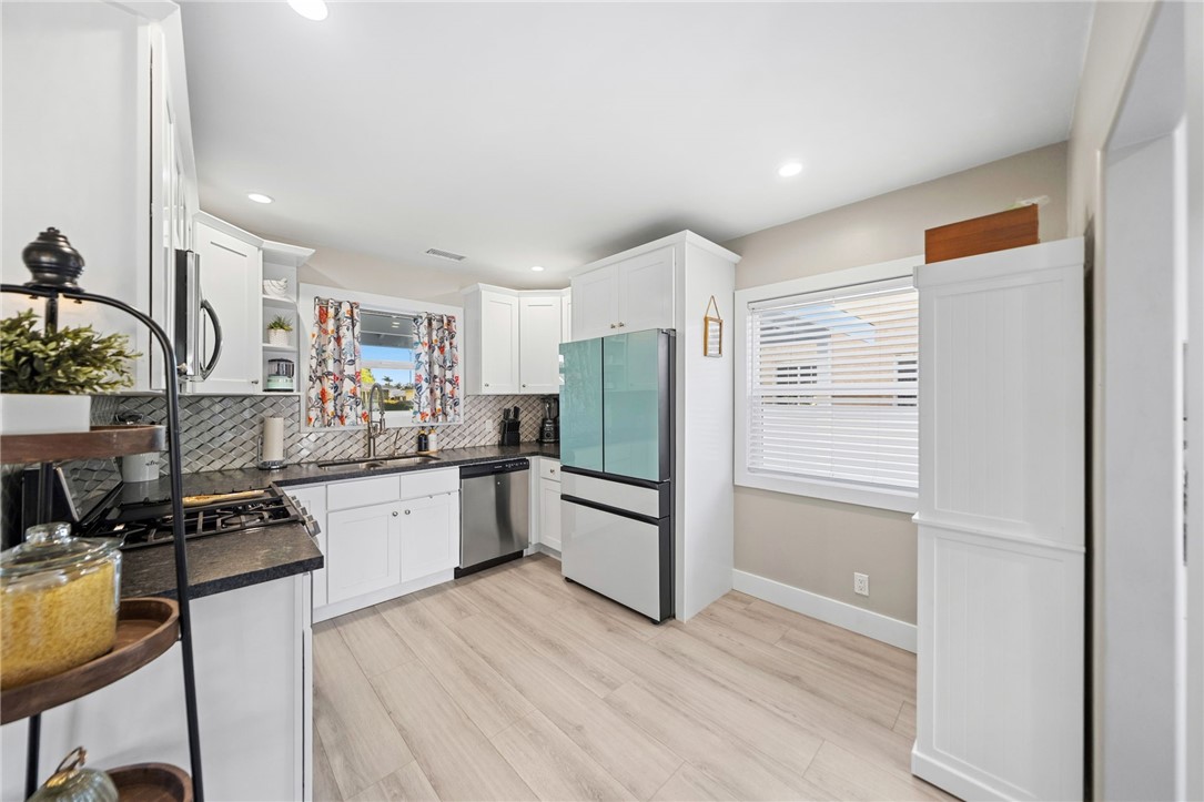 Upgraded kitchen, recessed lighting, white cabinets, smart appliances and osmosis water system. - 1711 W 21st, Santa Ana CA 92706 - photo 13