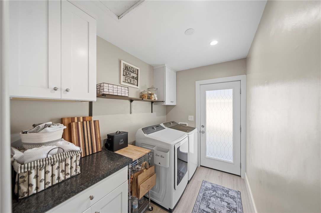Cabinets and countertops in laundry match kitchen finishes. - 1711 W 21st, Santa Ana CA 92706 - photo 18
